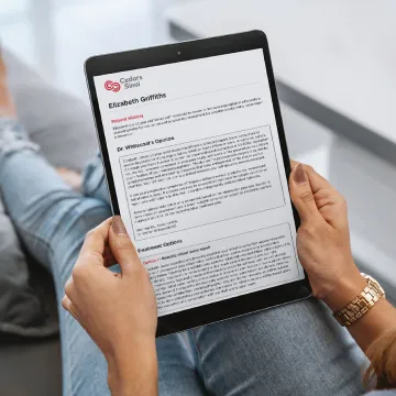 patient holding a tablet with a written report